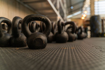 Close-up of kettlebells on floor at gym