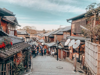 Street amidst buildings in town against sky