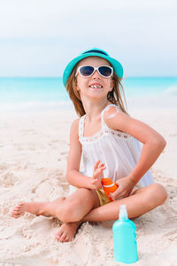 Portrait of girl wearing sunglasses at beach