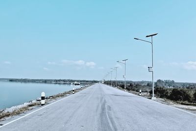 Road by sea against sky