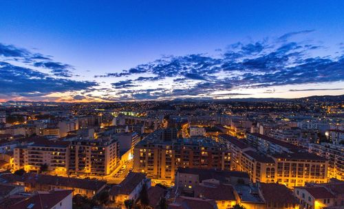 High angle view of illuminated cityscape against sky