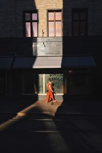 Side view of woman walking on street