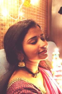 Close-up portrait of young woman with eyes closed