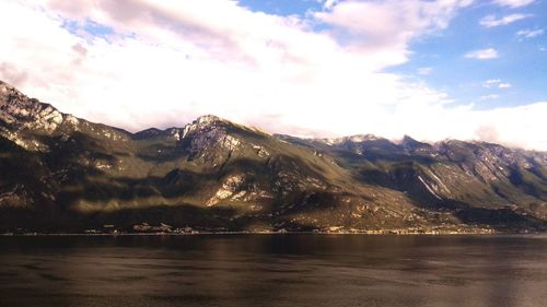 Scenic view of mountains against cloudy sky