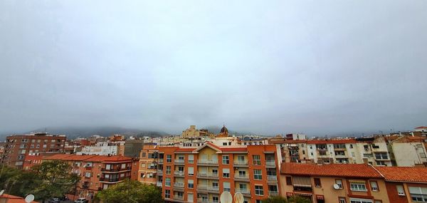 Houses in town against sky