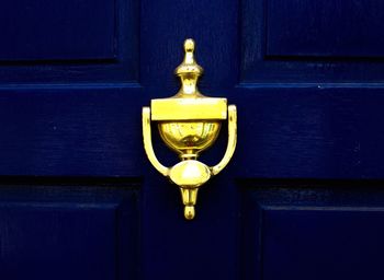 Close-up of gold door knocker