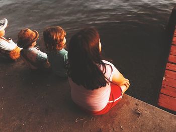 Rear view of women sitting in water