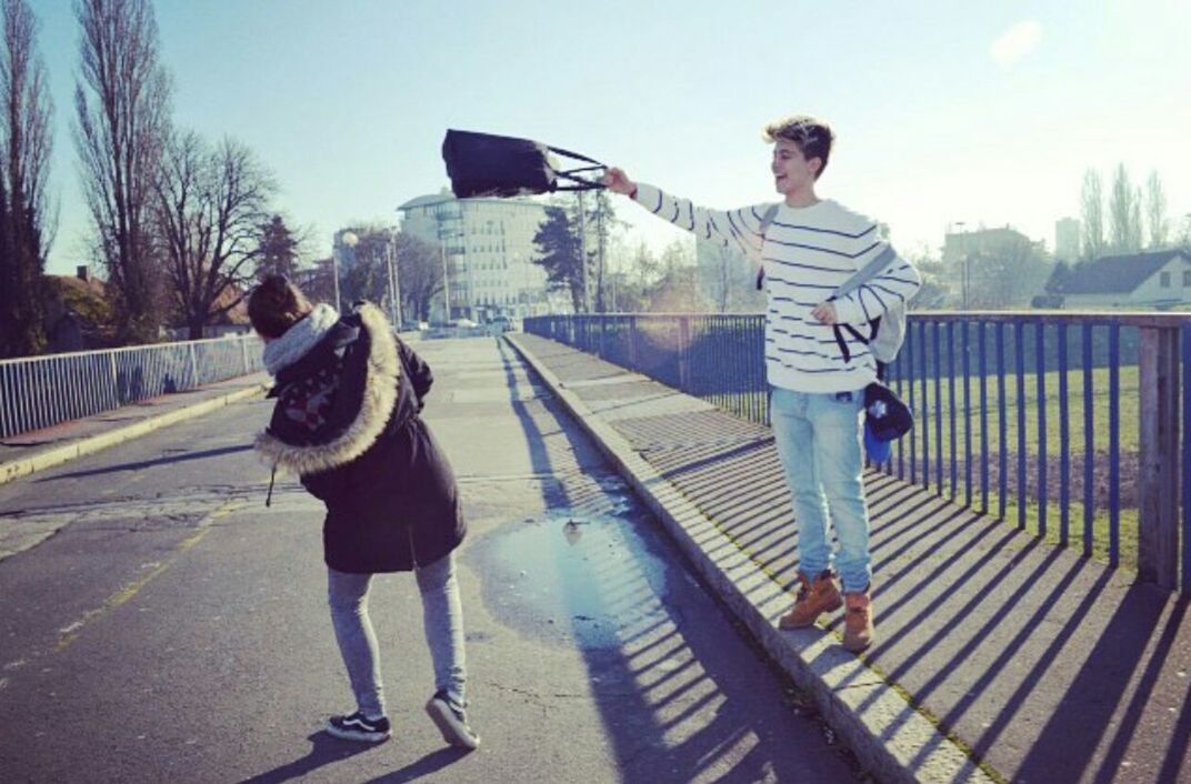 full length, lifestyles, casual clothing, leisure activity, person, built structure, building exterior, architecture, railing, standing, young adult, young men, transportation, sky, rear view, walking, sunlight