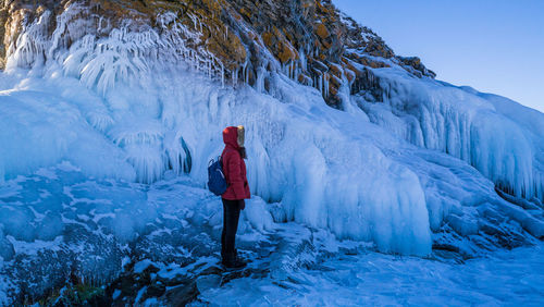 Woman standing on snow covered mountain