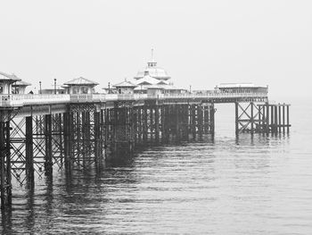 Pier on sea against clear sky