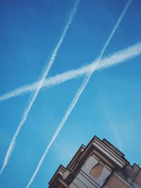 Low angle view of vapor trails in sky