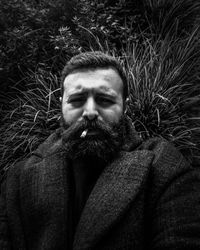 Portrait of man standing against plants