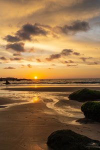 Scenic view of beach against sky during sunset