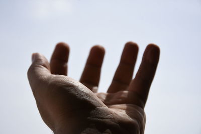 Close-up of human hand against white background