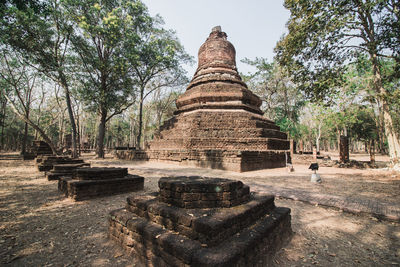 View of old temple against building