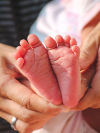 Cropped image of hand holding baby