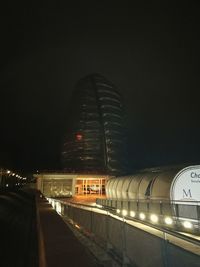 Illuminated road against sky at night