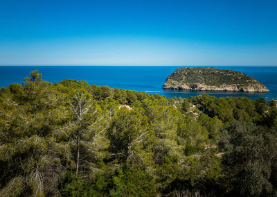 Scenic view of sea against clear blue sky