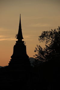 Silhouette of pagoda against sky during sunset