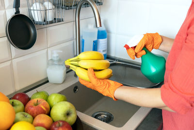 Midsection of woman preparing food at home