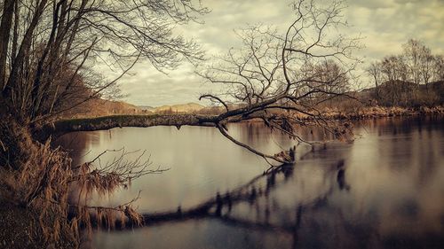 Scenic view of lake against cloudy sky