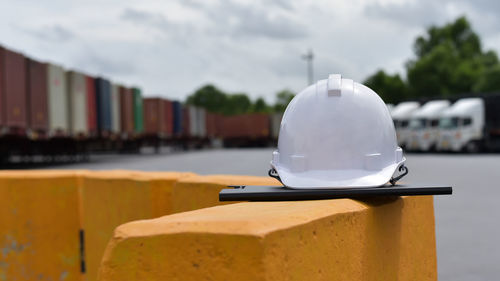 Close-up of hardhat and file on retaining wall