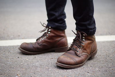 Low section of man wearing shoes