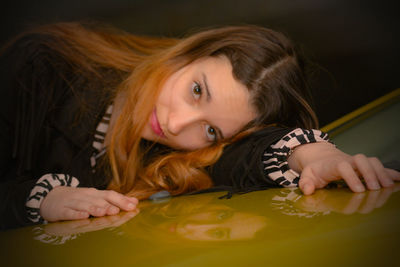 Portrait of woman lying on floor