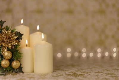 Close-up of christmas decorations with candles on table