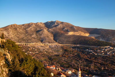 Scenic view of mountains against clear blue sky