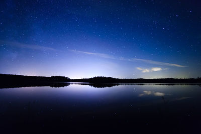 Scenic view of lake against star field at night