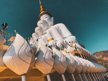 Low angle view of sculptures on building against sky