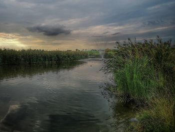 Scenic view of lake against sky during sunset