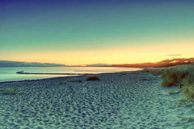 Scenic view of sea against clear sky during sunset