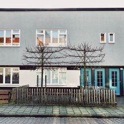 Residential building by street against sky