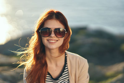 Portrait of smiling young woman wearing sunglasses