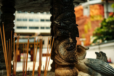 Close-up of statue against temple building