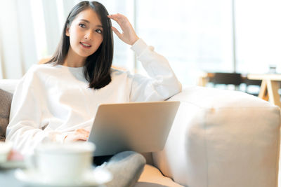 Portrait of young woman using mobile phone