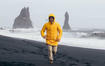 Full length of man standing on beach