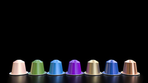 Close-up of colorful drinking straws against black background