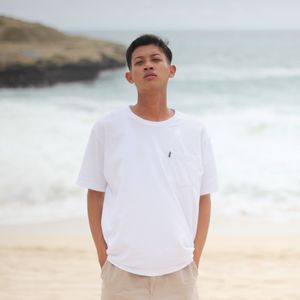 Portrait of young man standing at beach