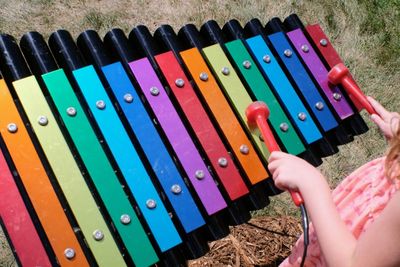 Midsection of girl playing musical instrument