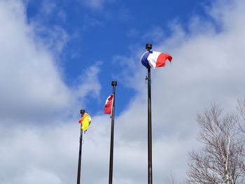 Low angle view of flag on pole against sky