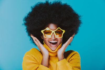 Portrait of woman against blue background