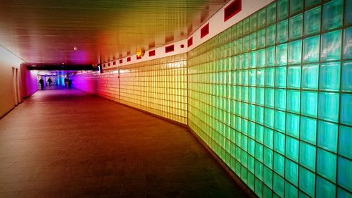 Empty subway along glass block wall