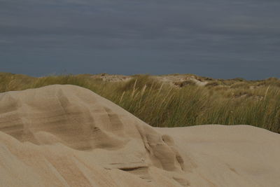 Scenic view of dune against sky