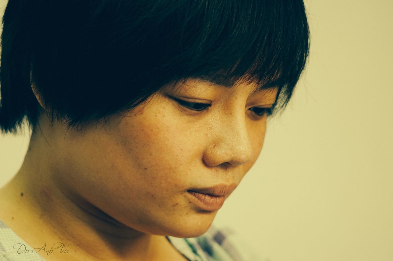 headshot, person, indoors, close-up, lifestyles, human face, portrait, looking at camera, young adult, contemplation, front view, serious, head and shoulders, leisure activity, young women, focus on foreground, thoughtful