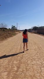 Rear view of woman standing on beach