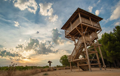 Low angle view of hut against sky during sunset