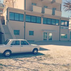 Car on street by buildings in city